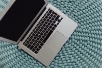 MacBook Laptop on a blue pouf