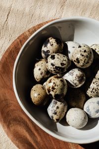 Quail eggs on wooden plate