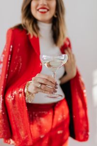 Kaboompics - Woman in red pants and a white shirt with champagne
