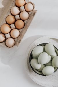 Kaboompics - Easter flat lay with green eggs on a white marble