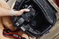 Kaboompics - Photographer holding a DSLR camera