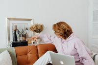 Woman uses a laptop - working from home - Macbook Air - Candles