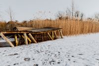 Old pier on the frozen lake