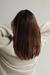 The back of a young woman - medium-length brown straight hair