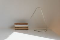 Minimalist Desk Setup with Books and Modern Lamp