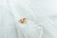 Golden rings on a white veil