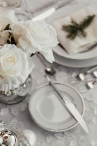 White flowers on a table with porcelain tableware