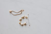 Kaboompics - Gold jewellery in white marble - bracelets with shells
