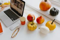 Kaboompics - Female desk with orange notebook and pumpkins