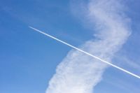 Airlane contrails on a cloudy blue sky