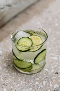 Water glass - cucumber - ice cubes - concrete stairs