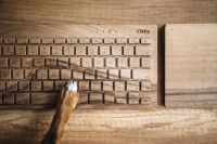 Kaboompics - Dogs paw on the wooden keyboard