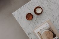 Minimal Marble Table With Wooden Candle Holders and Magazine