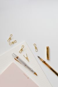 Kaboompics - Fountain pens, clips and notebooks on a white desk