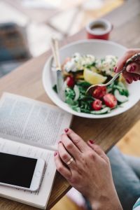 Kaboompics - Woman eating breakfast and reading a book