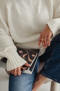 Kaboompics - Woman in a white sweater - jewelry - laptop work - fashion