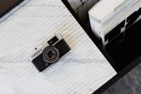 Kaboompics - Old camera on marble - top view