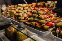An assortment of olive snacks displayed for sale at San Miguel market.