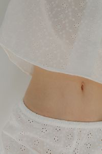 Kaboompics - Woman in white cotton pajamas - belly - navel
