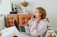 Kaboompics - Woman uses laptop - working from home - talking on the mobile phone