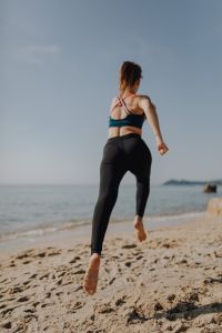 Kaboompics - Woman jogging on the beach - running