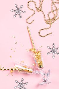 New Years Eve party decorations on pink background