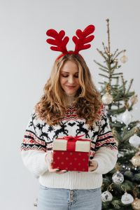 Kaboompics - Woman with Gifts Wearing Christmas Sweater and Reindeer Horns on Head