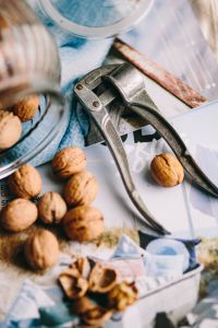 Kaboompics - Glass jar full of walnuts and a nutcracker