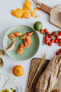 Kaboompics - Orange - tomatos - bread -  cutting board ona table