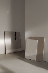 Kaboompics - Artistic arrangement of neutral-colored canvases resting against a wall