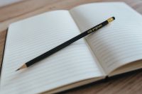 Kaboompics - Empty notebook with a black pencil on a wooden desk