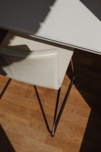 White Leather Chair with Sunlight on Wooden Floor