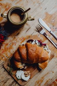 Kaboompics - Croissant with goat cheese, beetroot and a cup of coffee for breakfast