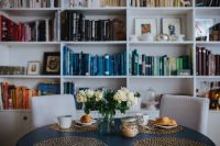 Kaboompics - Round breakfast table with white flowers by the bookcase