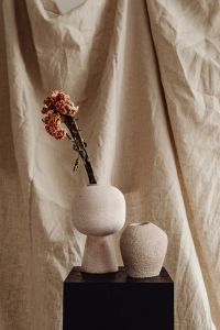 Earthenware Vases with Dried Flowers on Linen Background
