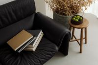 Kaboompics - Black Leather Sofa with Wooden Stool - Japandi Living Room - Books