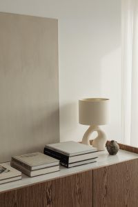 Ceramic lamp styled on a commode with a stone top
