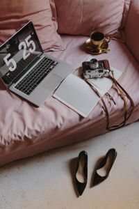 Kaboompics - Workplace with a laptop, organizer, high heels, old camera shoes and coffee on a pink couch