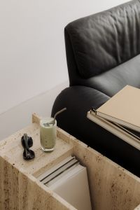 Matcha Latte on Travertine Table Next to Black Leather Sofa - Japandi Style