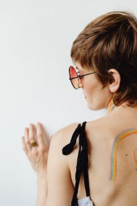 Girls paint an LGBT rainbow on their bodies