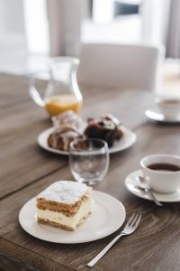 Kaboompics - Sweet dessert with cream and a cup of coffee on a table
