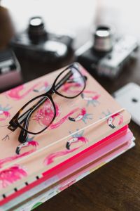 Kaboompics - Corrective glasses on a stack of notebooks