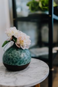 Peony flowers in vase on marble table