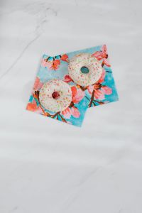 Kaboompics - Donuts on paper napkins placed on white marble