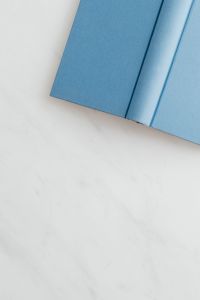 Kaboompics - Blue open book on marble table