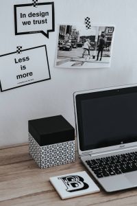 Inspirational cards with quotes, a black-and-white photo and a silver laptop
