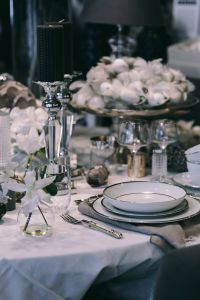 Fancy restaurant dinner table decorated with quail eggs and feathers
