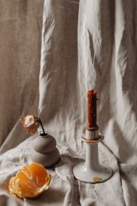 Kaboompics - Candle - linen fabric - mandarine - dried rose