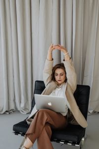 Elegant businesswoman wears pearls - stretching your body - tired at work