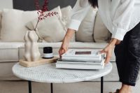 Kaboompics - Marble round table - linen sofa - beige - living room - vase - candle - dries - Asian adult woman - books